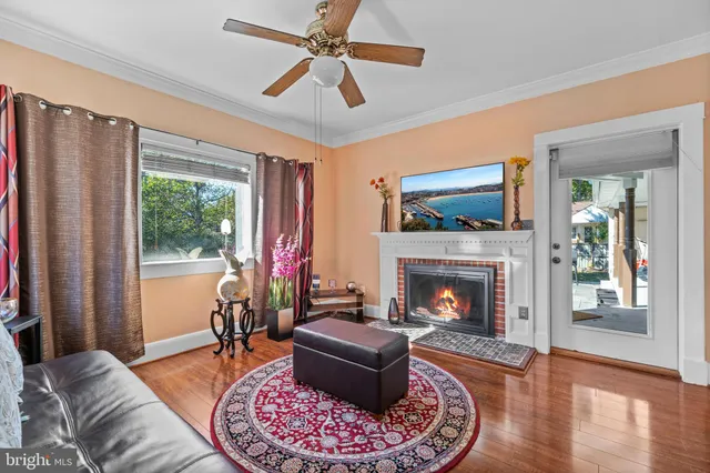 a living room with furniture fireplace and window