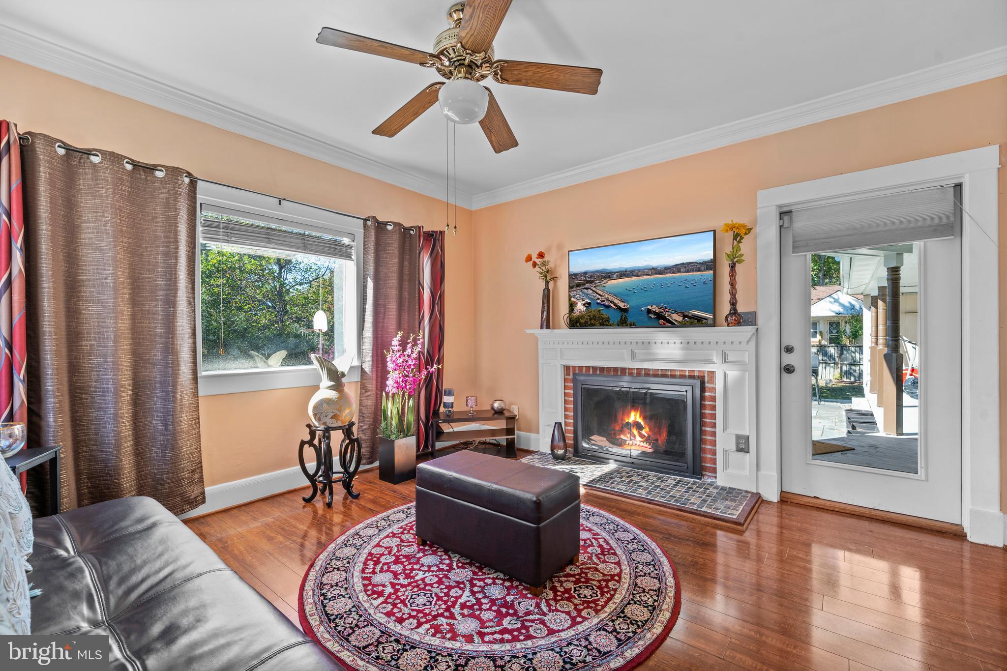 a living room with furniture fireplace and window