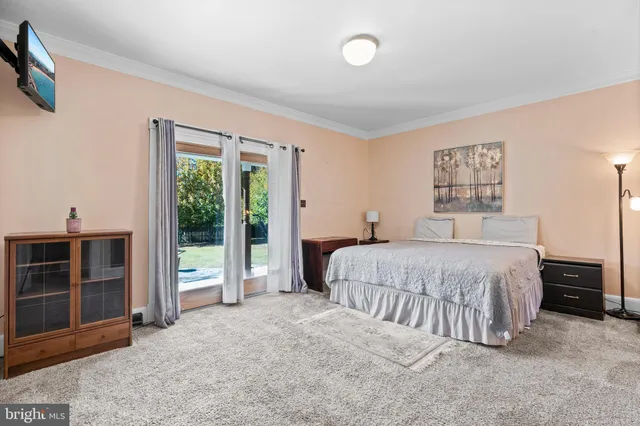 a bedroom with a bed and a large window
