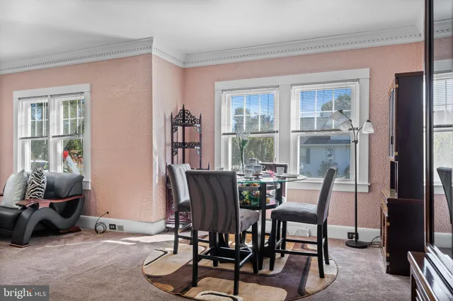 a dining room with furniture and window