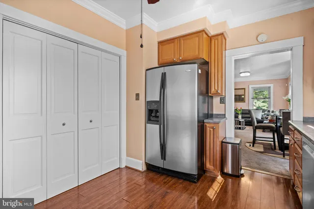 a kitchen with stainless steel appliances a refrigerator and wooden floor