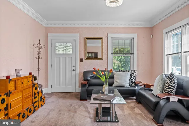 a living room with furniture rug and window