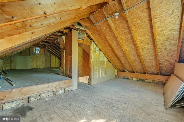 a view of a patio with table and chairs potted plants and floor to ceiling window