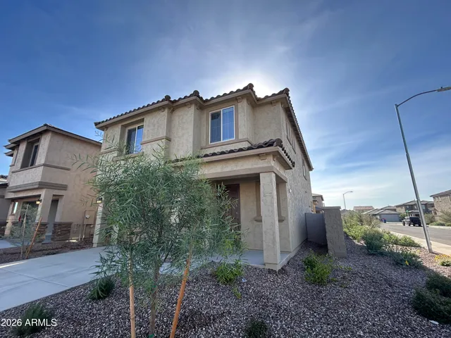 a view of a house with a yard and balcony