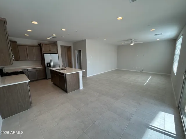 a view of kitchen and kitchen with stainless steel appliances granite countertop cabinets