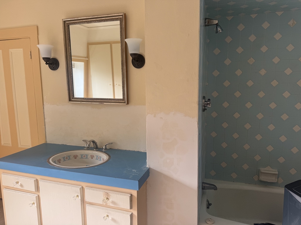 39 Belmont Street, Unit 2 Fall River, MA 02720 - Photo 10 of 10 a bathroom with a sink a mirror and a shower