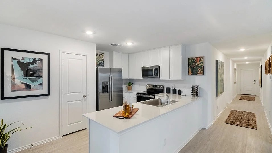 217 Skyfire Street Hutto, TX 78634 - Photo 3 of 15 a kitchen with stainless steel appliances granite countertop a refrigerator and a stove top oven