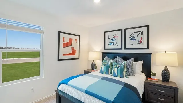 a bedroom with a bed and a painting on the wall