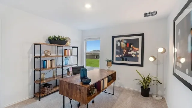 a work room with furniture and a book shelf