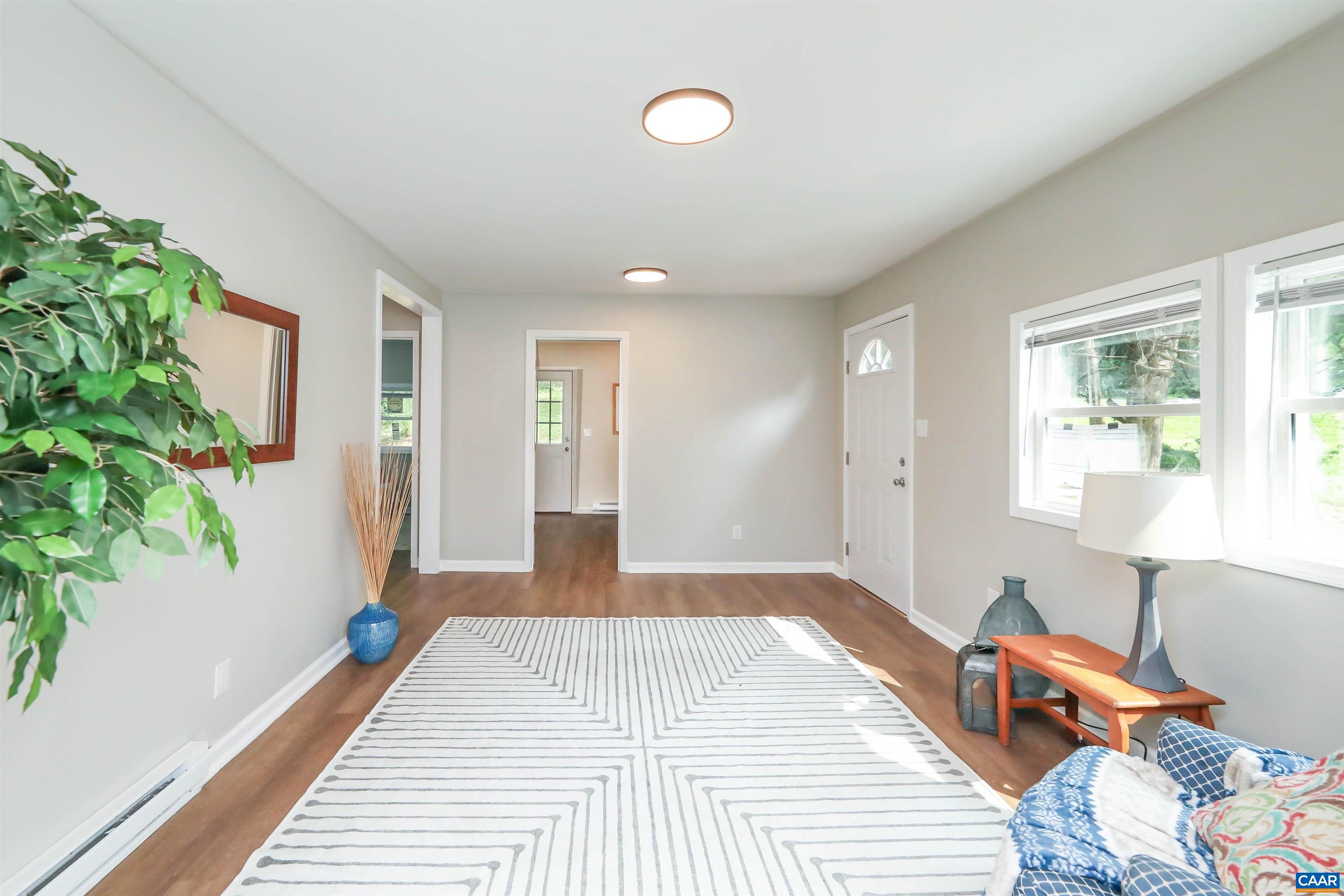 8901 Chestnut Grove Road Esmont, VA 22937 - Photo 11 of 44 a bedroom with a bed and a potted plant