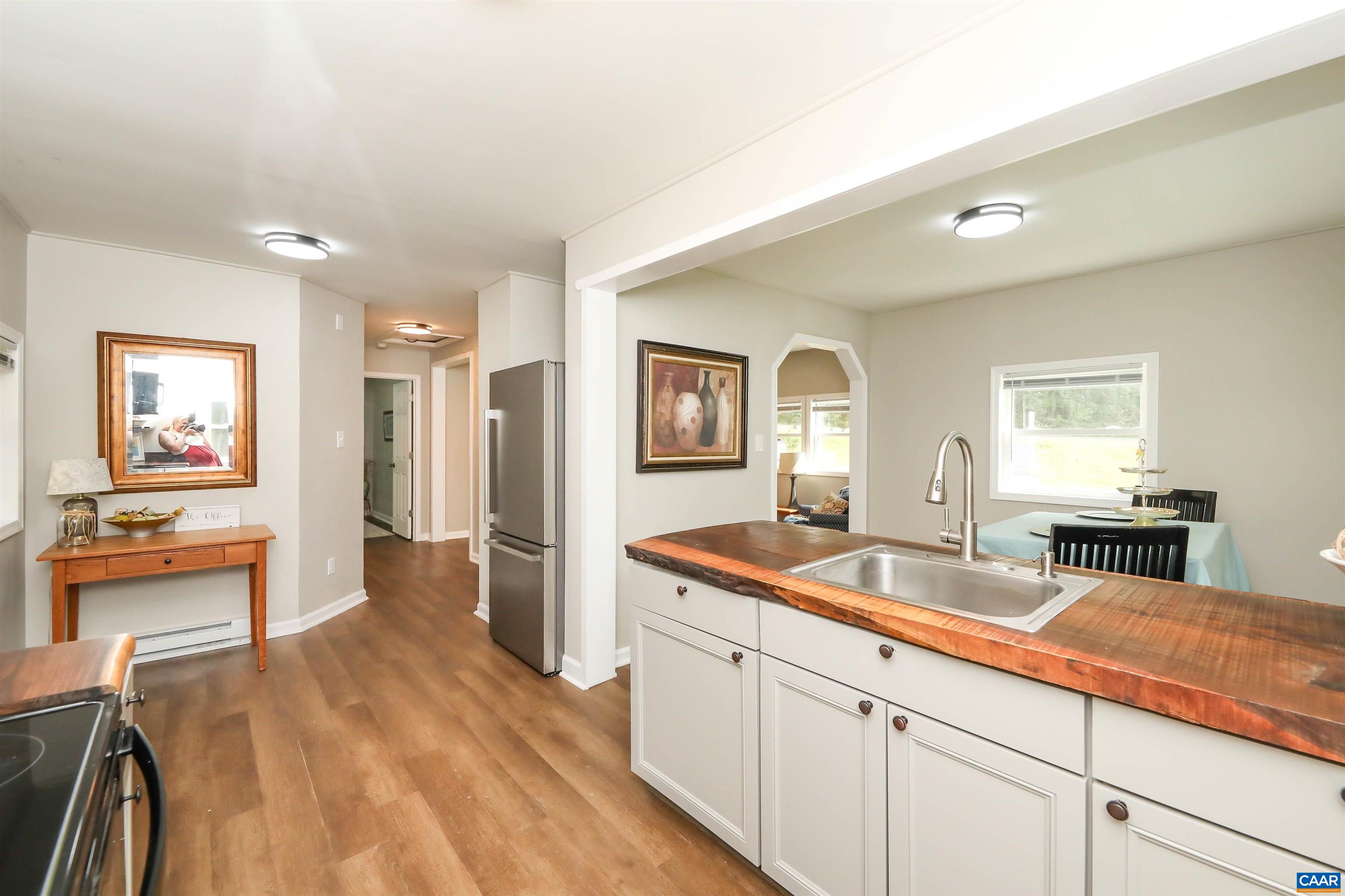 8901 Chestnut Grove Road Esmont, VA 22937 - Photo 14 of 44 a spacious bathroom with a granite countertop sink and a mirror