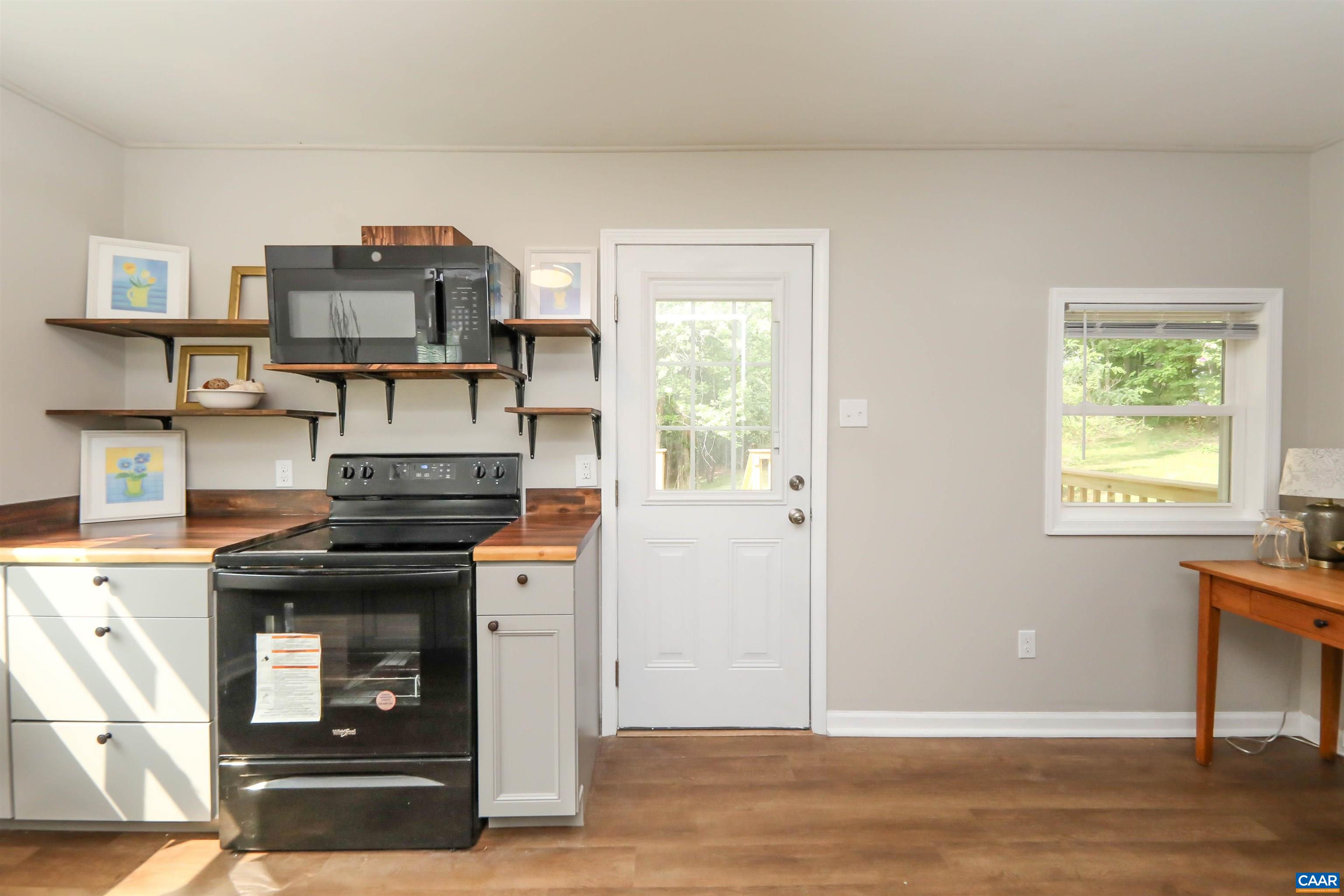 8901 Chestnut Grove Road Esmont, VA 22937 - Photo 15 of 44 a kitchen with a stove and a cabinets