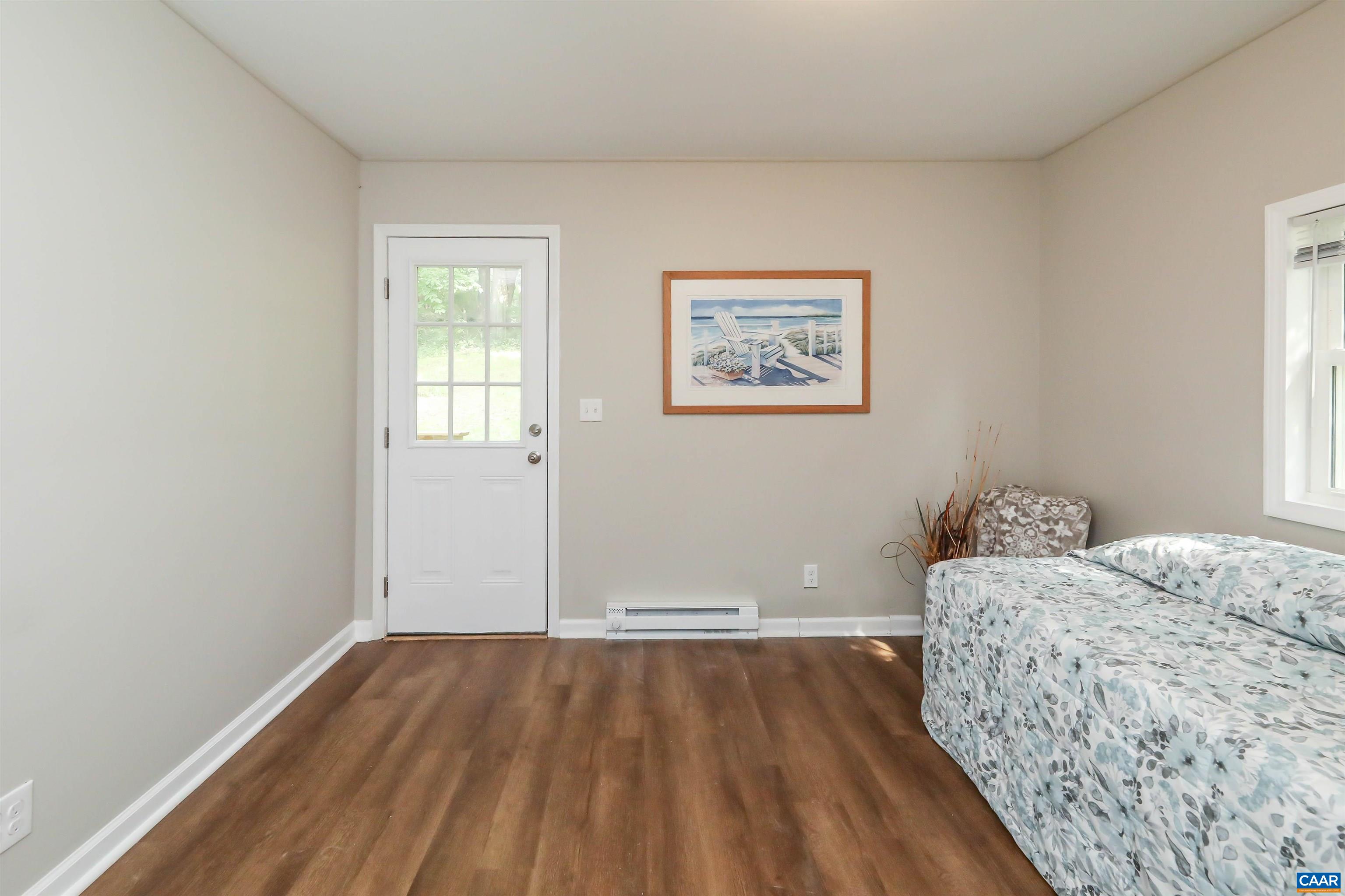 8901 Chestnut Grove Road Esmont, VA 22937 - Photo 23 of 44 a bedroom with a bed and wooden floor