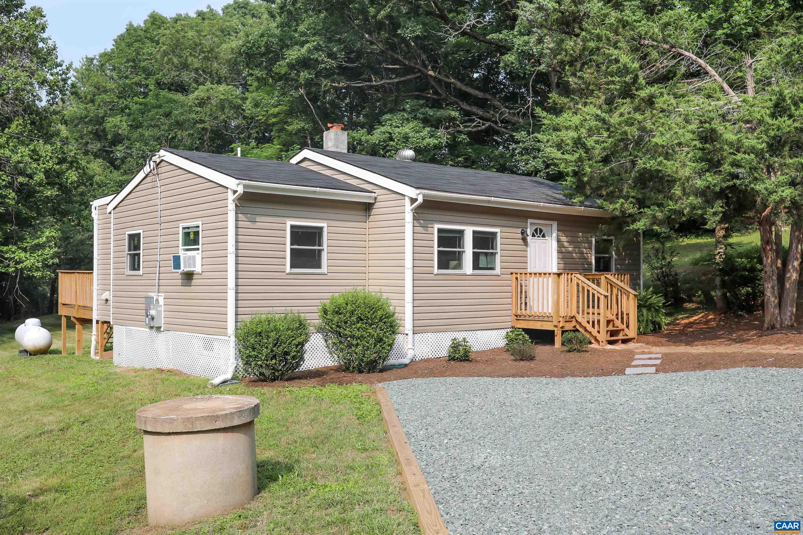 8901 Chestnut Grove Road Esmont, VA 22937 - Photo 37 of 44 a backyard of a house with table and chairs