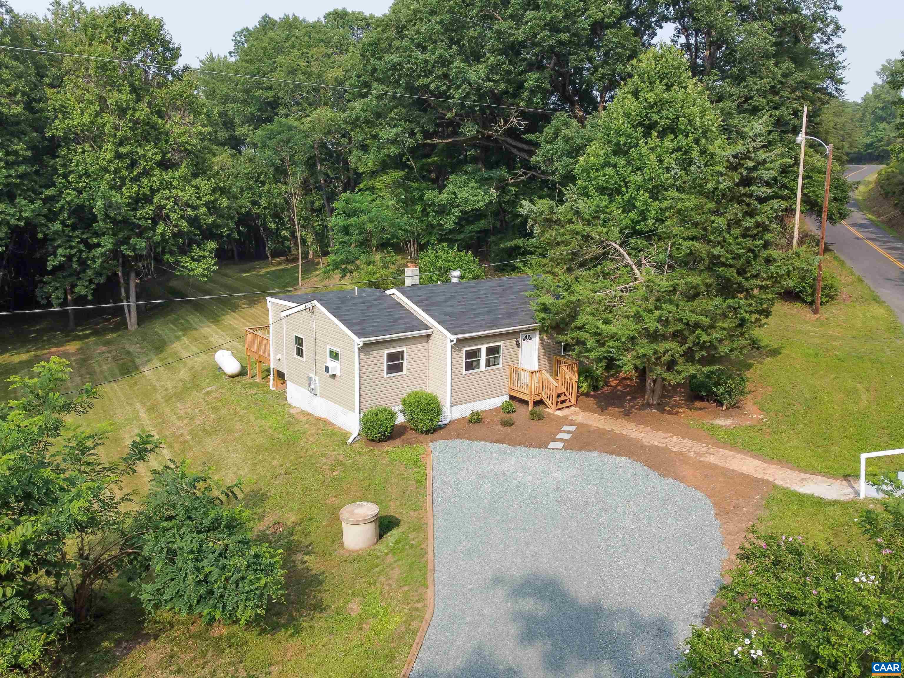 8901 Chestnut Grove Road Esmont, VA 22937 - Photo 39 of 44 an aerial view of a house with swimming pool and large trees