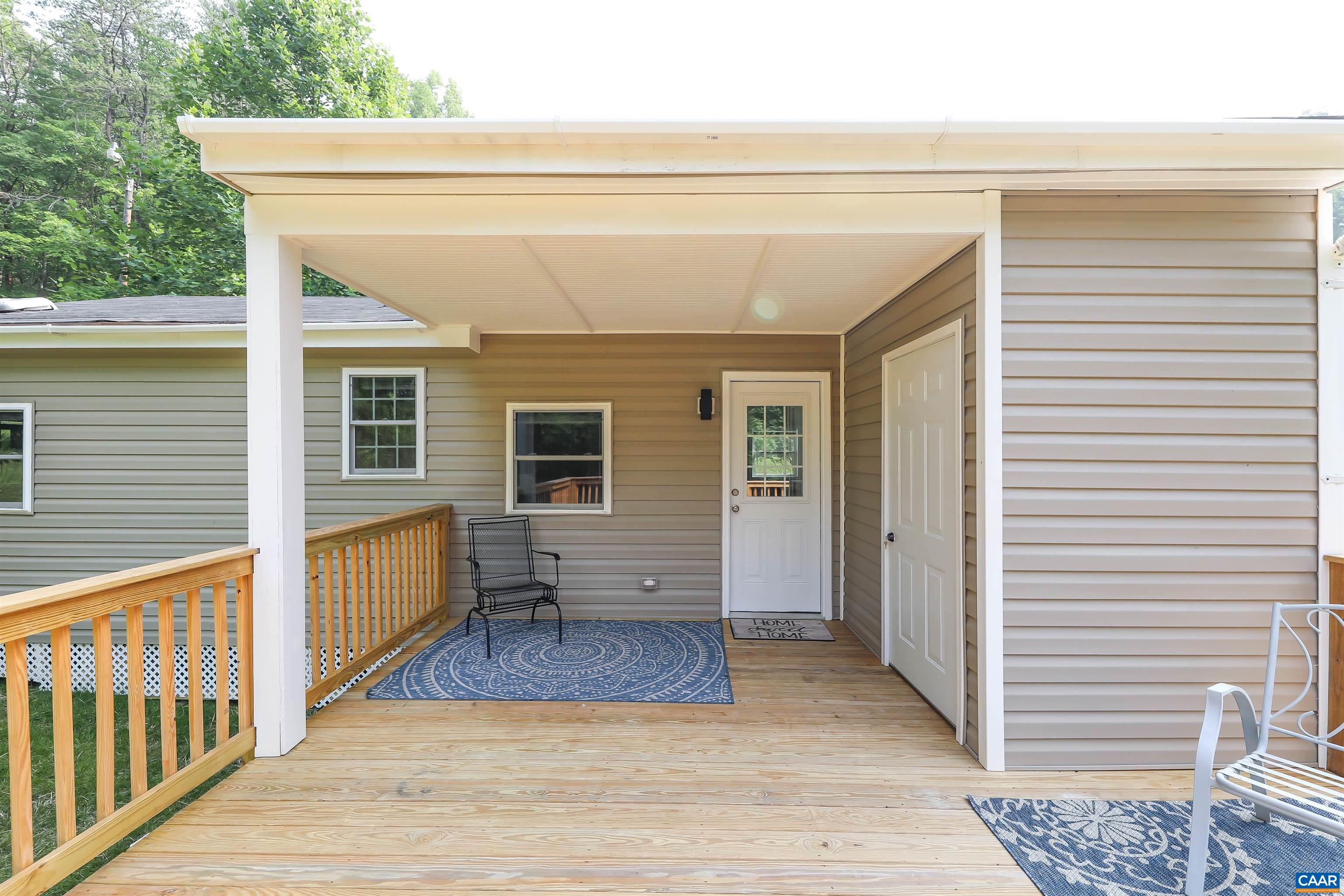 8901 Chestnut Grove Road Esmont, VA 22937 - Photo 5 of 44 a view of a porch with wooden floor and fence