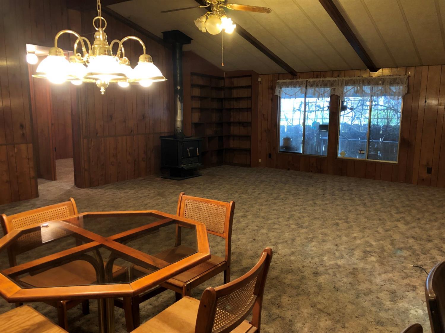 6226 East Evans Creek Road, Unit 15 Rogue River, OR 97537 - Photo 5 of 30 a room with table chairs and windows