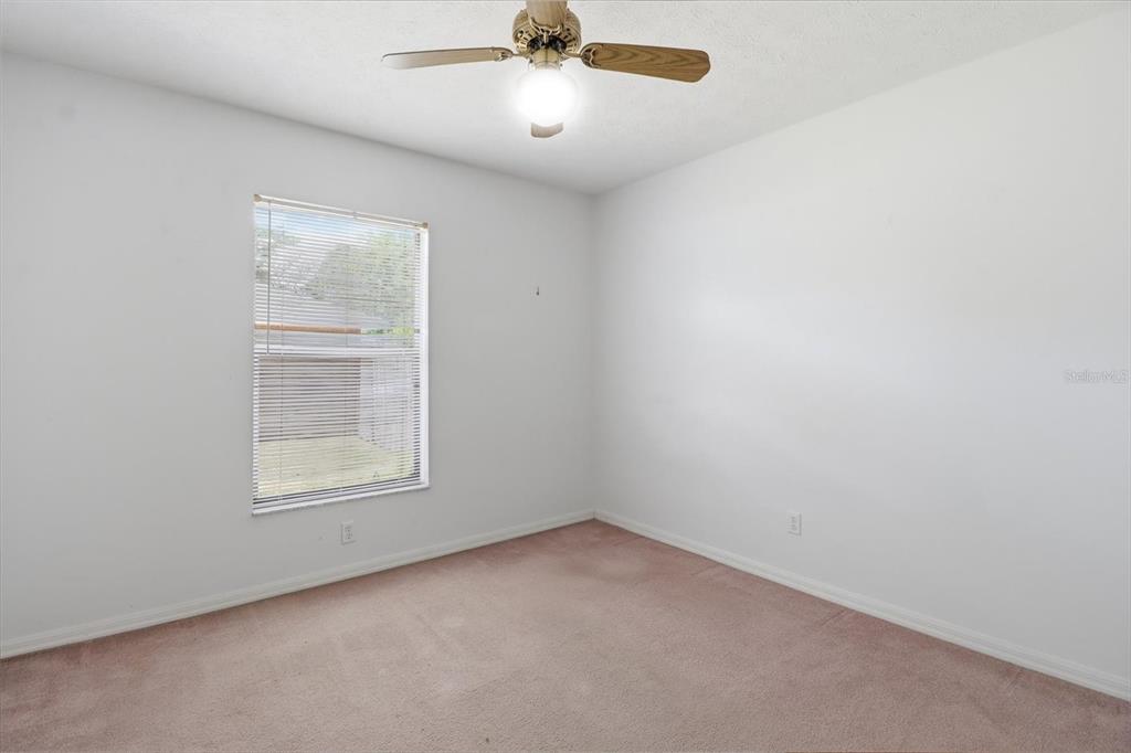 6355 East Rush Street Inverness, FL 34452 - Photo 15 of 27 an empty room with a window and a fan