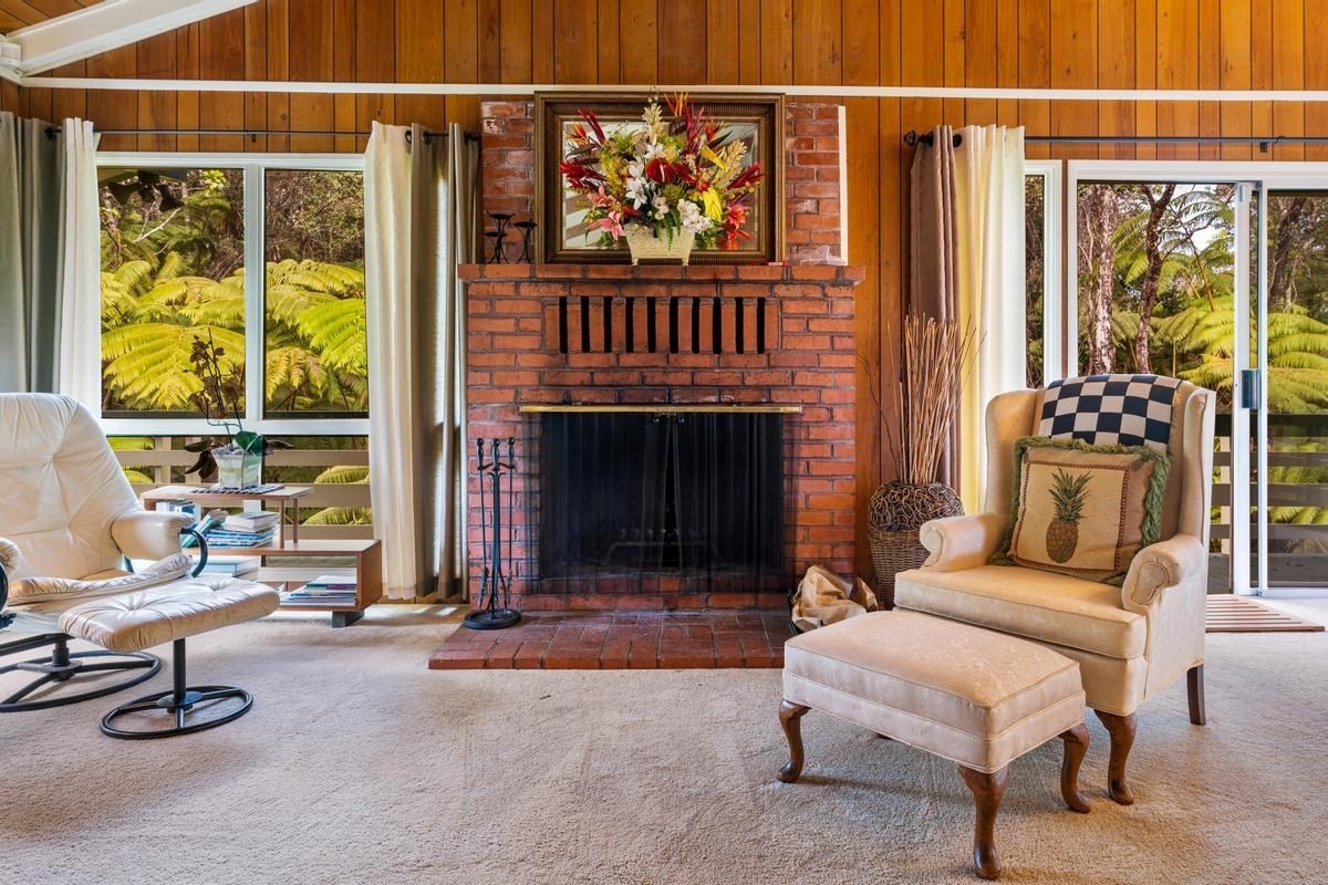 19-4252 Wright Road Volcano, HI 96785 - Photo 17 of 30 a living room with furniture a fireplace and a window