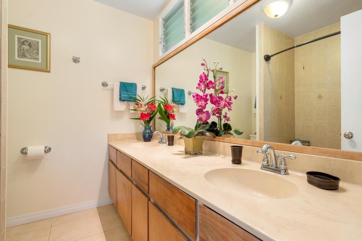 19-4252 Wright Road Volcano, HI 96785 - Photo 20 of 30 a bathroom with a granite countertop sink a large mirror and shower