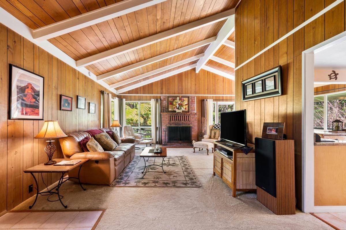19-4252 Wright Road Volcano, HI 96785 - Photo 6 of 30 a living room with furniture a flat screen tv and floor to ceiling window