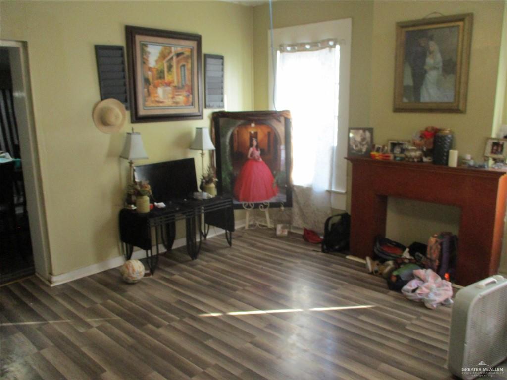 207 South Avasolo Street Rio Grande City, TX 78582 - Photo 2 of 8 a living room with furniture a fireplace and wooden floor