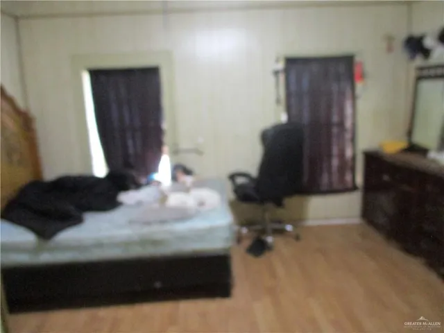 a living room with furniture gym equipment and a large window