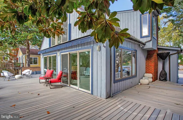 a view of a two chair and table in the wooden deck