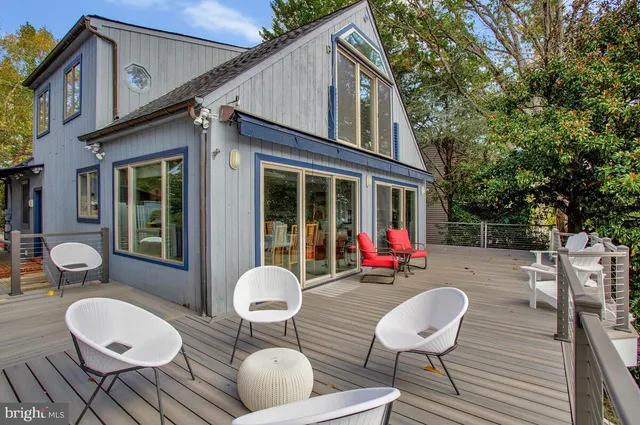 a view of a patio with couches table and chairs and potted plants