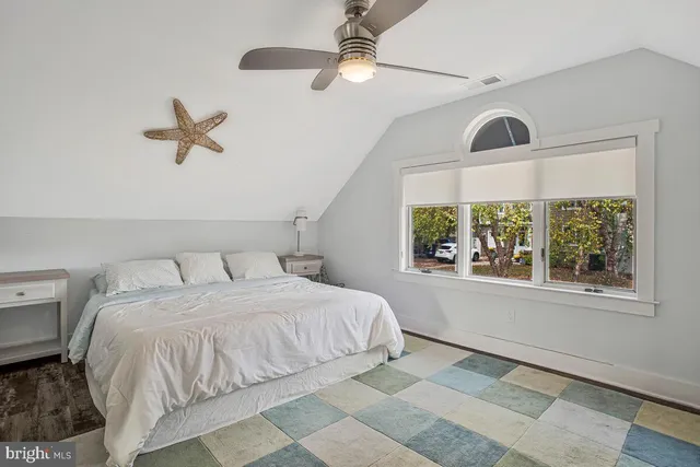 a bedroom with a large bed and a window