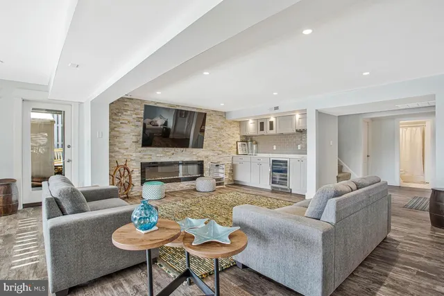 a living room with furniture flat screen tv and a fireplace