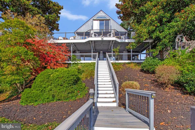 a front view of a house with yard and patio