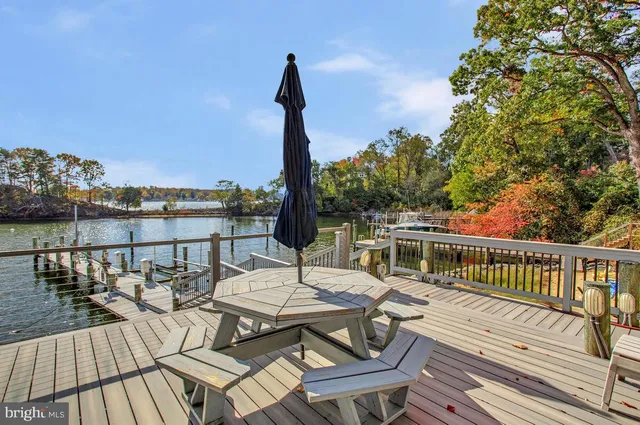 a view of a balcony with wooden floor and outdoor seating