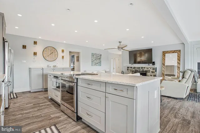a kitchen with white cabinets stainless steel appliances and a counter top space