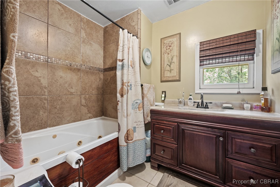 5447 Mobjack Road Gloucester, VA 23061 - Photo 13 of 40 Bathroom with tile patterned flooring, shower / bathtub combination with curtain, and vanity