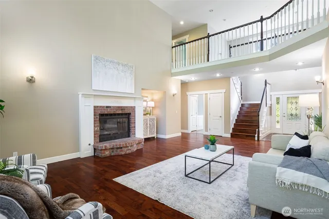 a dining room with furniture a chandelier and wooden floor