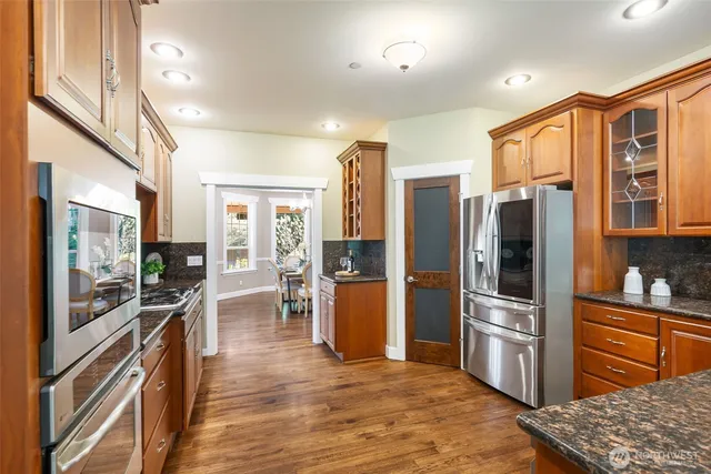 a dining room with furniture window and wooden floor