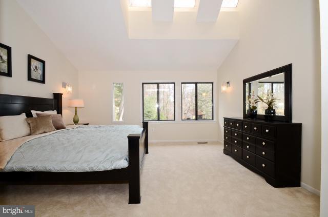 7307 Hooking Road McLean, VA 22101 - Photo 17 of 29 a large bedroom with a bed and a large mirror