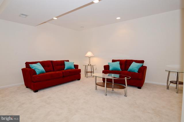 7307 Hooking Road McLean, VA 22101 - Photo 19 of 29 a living room with furniture a couch and a dining table