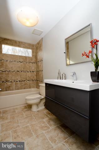 7307 Hooking Road McLean, VA 22101 - Photo 20 of 29 a bathroom with a sink and a mirror