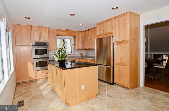 7307 Hooking Road McLean, VA 22101 - Photo 3 of 29 a kitchen with stainless steel appliances a refrigerator a oven a sink counter space and a window