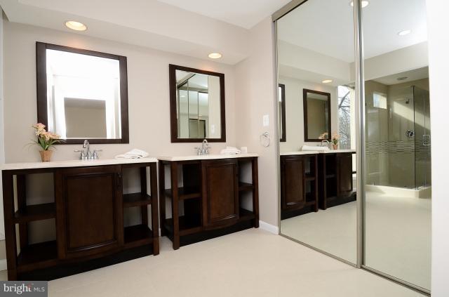 7307 Hooking Road McLean, VA 22101 - Photo 21 of 29 a bathroom with a double vanity sink and a mirror