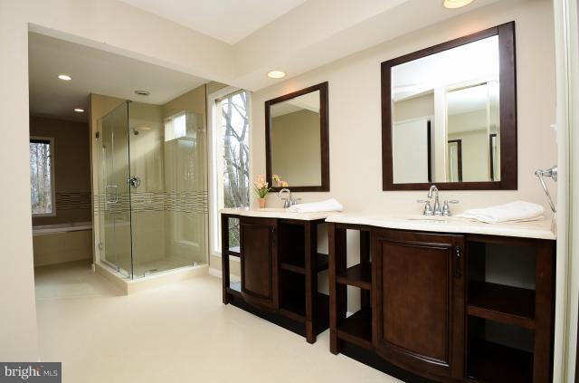 7307 Hooking Road McLean, VA 22101 - Photo 27 of 29 a bathroom with double vanity sinks and a shower