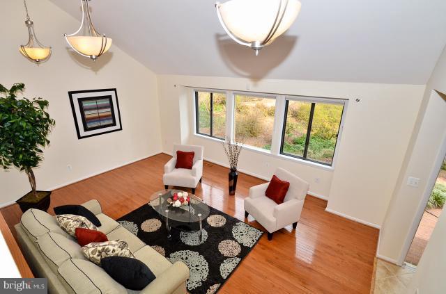 7307 Hooking Road McLean, VA 22101 - Photo 4 of 29 a living room with furniture and a chandelier