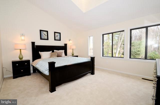 7307 Hooking Road McLean, VA 22101 - Photo 10 of 29 a large bed sitting in a bedroom next to a window