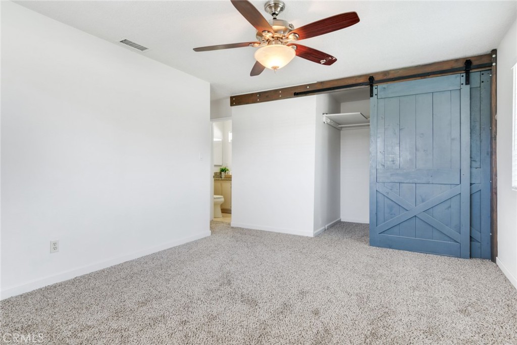 8955 Holly Lane Riverside, CA 92503 - Photo 6 of 32 an empty room with closet and a ceiling fan