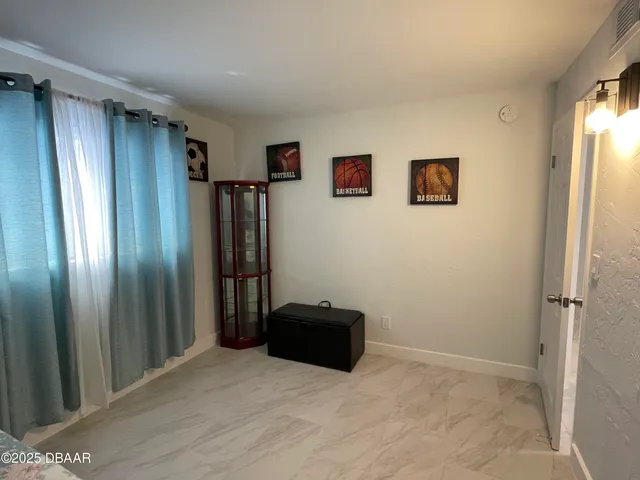a view of empty room with a refrigerator