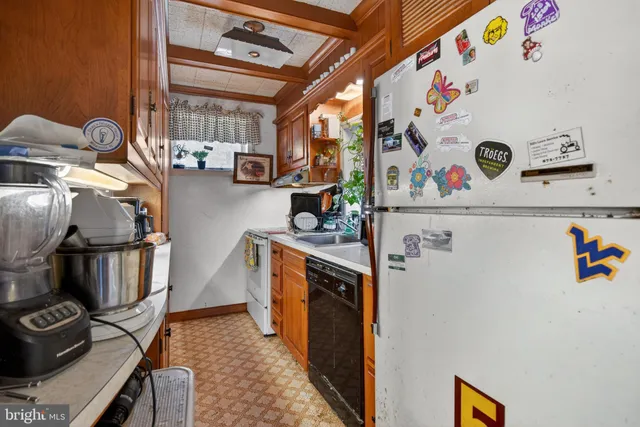 a kitchen with sink cabinets and appliances