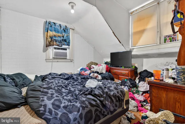 a bedroom with furniture and a wooden floor