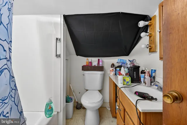 a living room with furniture and a baby crib